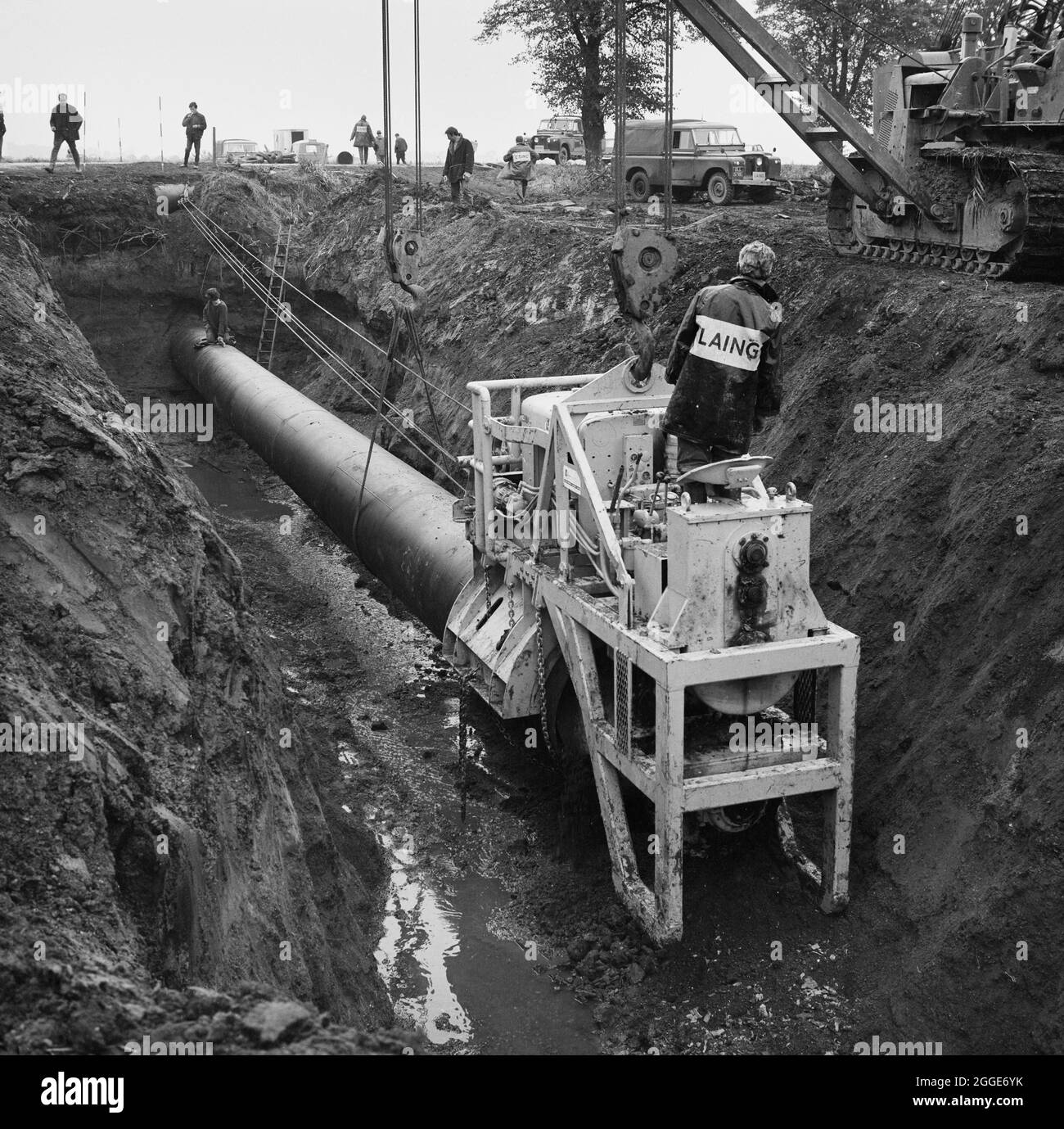 A view of thrust boring being carried out during the installation of the Fens gas pipeline. Work on laying the Fens gas pipeline started in June 1967 and was a joint venture between Laing Civil Engineering and French companies Entrepose and Grands Travaux de Marseille (GTM) for the Gas Council. Over 600 men worked on the project to lay 36 inch diameter steel pipes starting at West Winch in Norfolk and running to where it linked up with the next contract at Woodcroft Castle in Cambridgeshire. The pipeline crossed four rivers and numerous dykes and ditches. Stock Photo