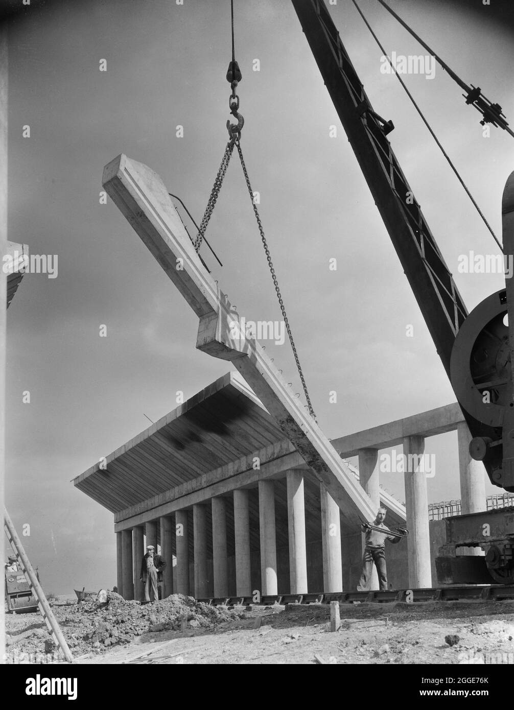 A precast cantilever beam being lifted into position during the construction of Structure 66, a railway underbridge on the London to Yorkshire Motorway (the M1). Structure 66 carried the Stratford on Avon, Towcester &amp; Midland Junction Railway under the motorway. The image shows in-situ columns, beams and abutment walls. Stock Photo