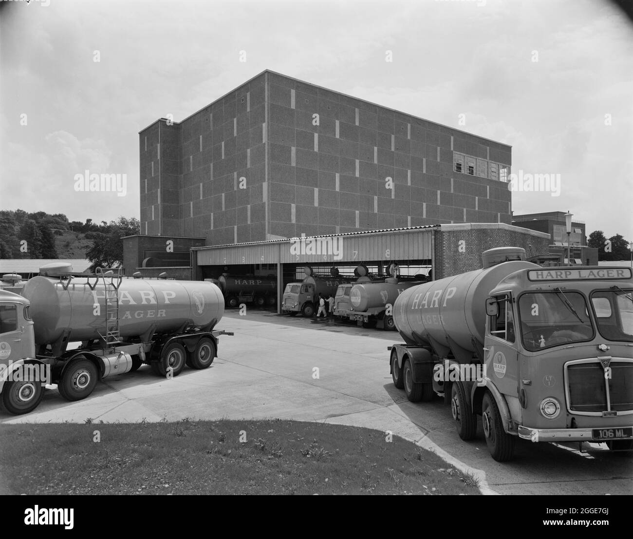 A view of tankers parked outside the new Harp Lager Brewery. The new brewery for Harp Lager at Manor Park was built by Laing with the design of the project being carried out by architects and engineers from the Group Technical Services, working with engineers from Arthur Guinness, Son and Company Limited. John Laing Construction Ltd began the building work in 1961 and the brewery was opened on 28th June 1963. The brewery was taken over by Bass in 1979, then later by Molson Coors, subsequently closing in 2015. Stock Photo