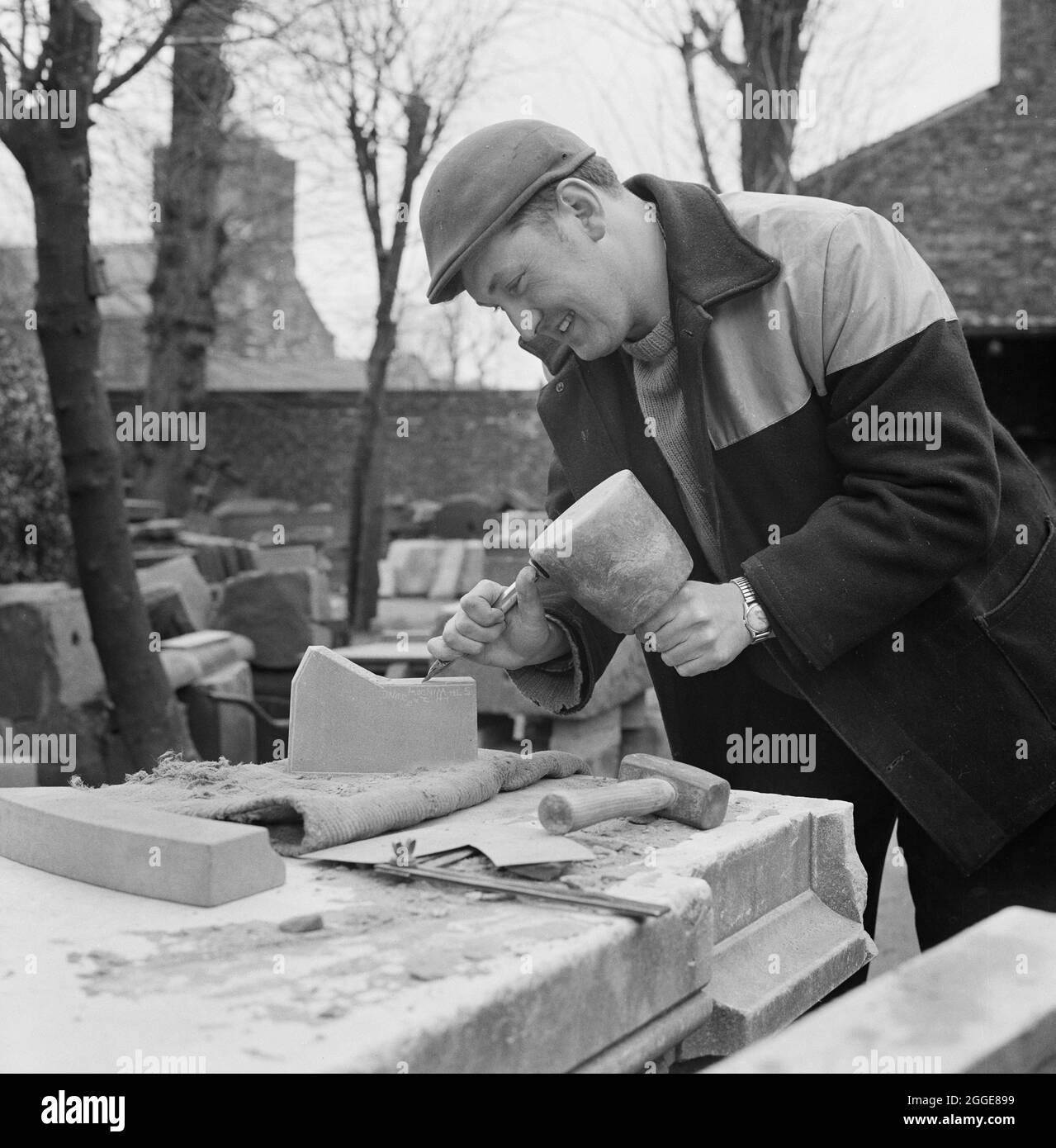A Stonemason Working On The Restoration Of Carlisle Cathedral Chiselling A Piece Of Stone Prior To It Being Bonded To The Existing Fabric Of The Cathedral With Sbd Certite This Photograph Is A Stonemason Working On The Restoration Of Carlisle Cathedral Chiselling A Piece Of Stone Prior To It Being Bonded To The Existing Fabric Of The Cathedral With Sbd Certite This Photograph Is