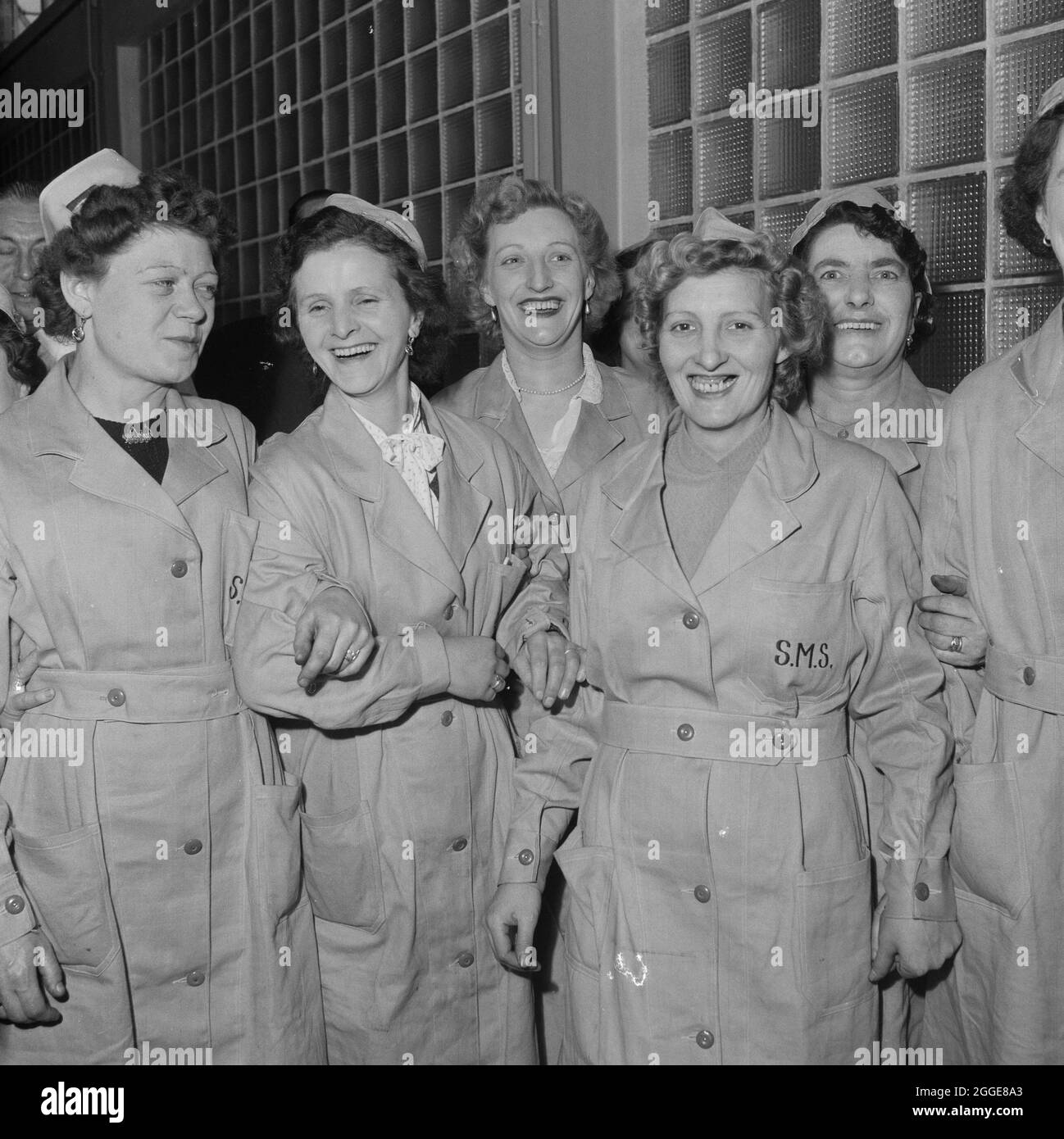 A group of female workers posed at the opening ceremony for the new bottling plant at the State-owned brewery in Carlisle. The opening ceremony of the bottling plant was performed by Sir Sydney O Nevile, a director of Whitbread's Brewery, but also a founder member of the State Management Districts Committee and the Central Control Board (Liquor Traffic) which had established the Carlisle State Management Scheme during the First World War. The bottling plant was built to supply increasing demand for bottled beers and in particular for those with no sediment. The plant had two lines of bottling Stock Photo