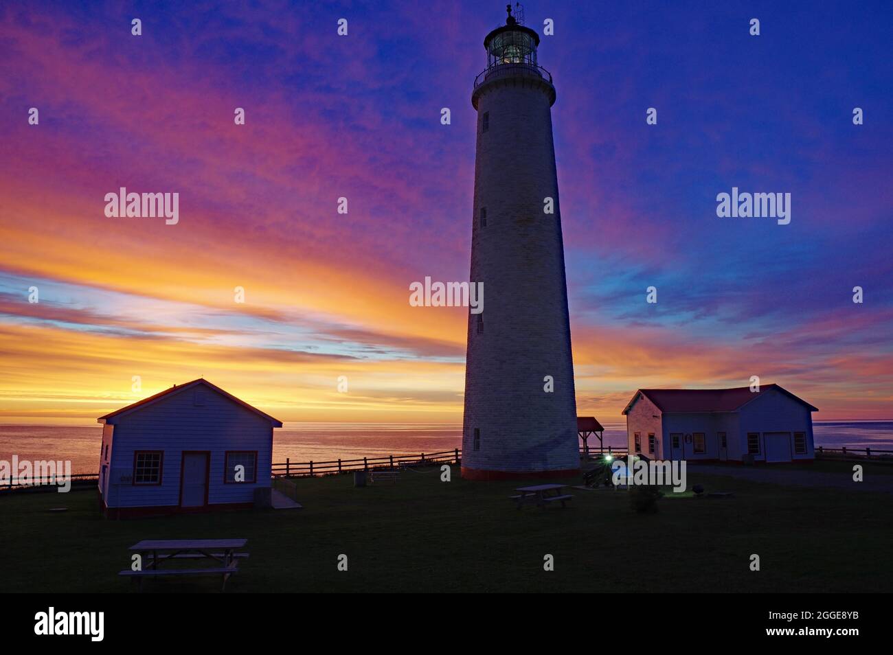Lighthouse and building, Cap-des-Rosiers lighthouse, Gaspesie, Quebec, Canada Stock Photo