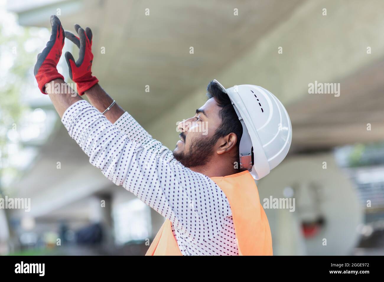 Young technician with beard working outside with helmet, Baden-Wuerttemberg, Germany Stock Photo