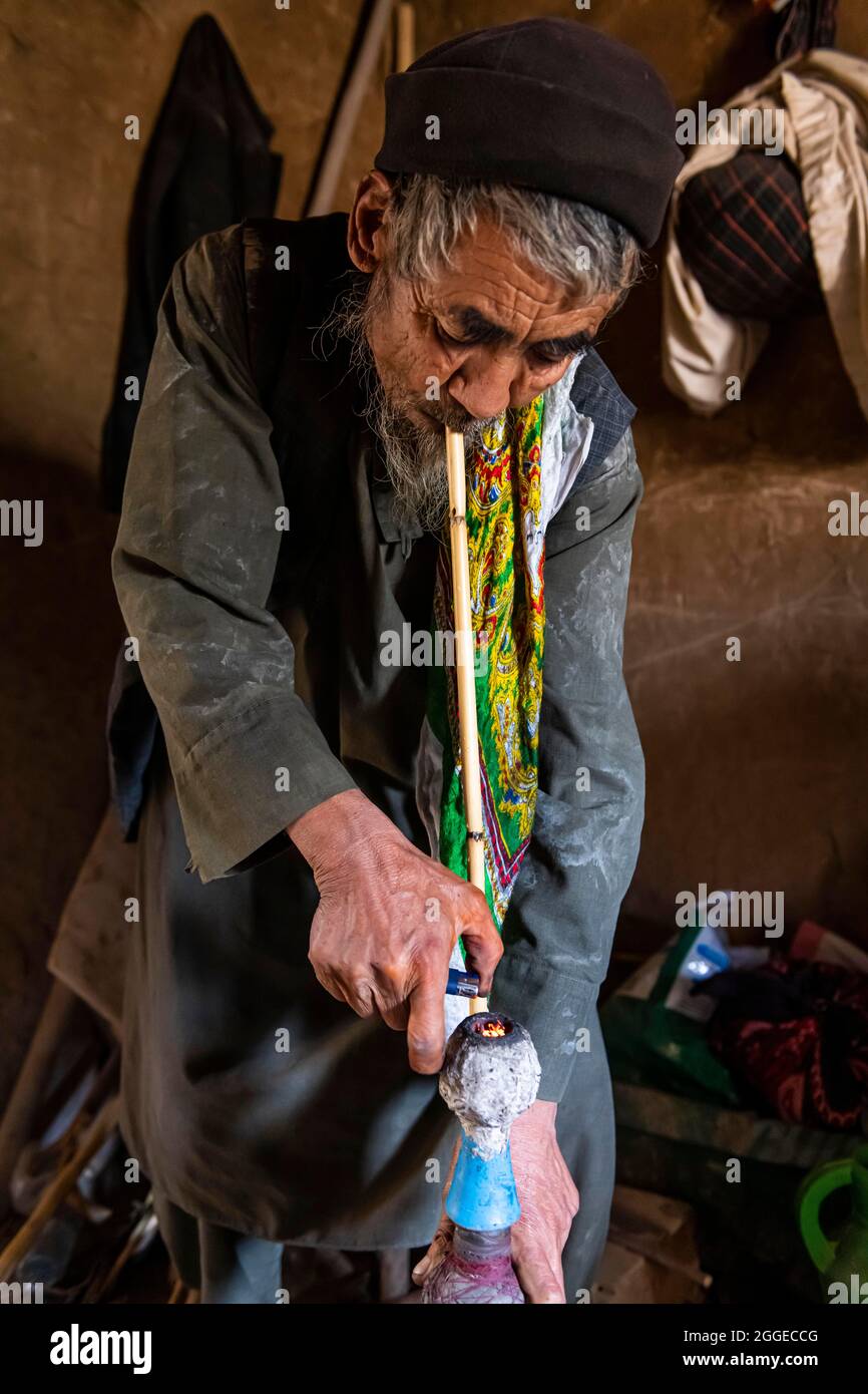 Sufi man preparing his marihuana pipe, Balkh, Afghanistan Stock Photo