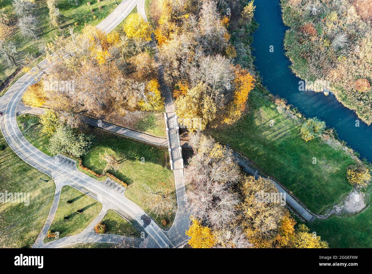footpaths and bicycle lane in the park. autumnal landscape with yellow ...