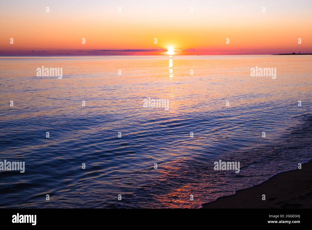 View from beach at sunset with ocean, colorful sky and sea Stock Photo