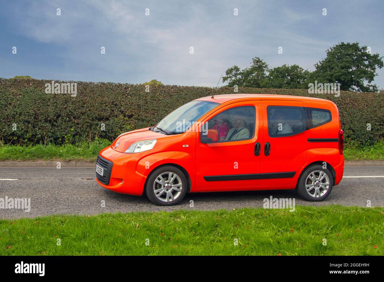 2012 orange Fiat Qubo MultiJet MyLife Dualogic en-route to Capesthorne Hall classic & vintage August car show, Cheshire, UK Stock Photo