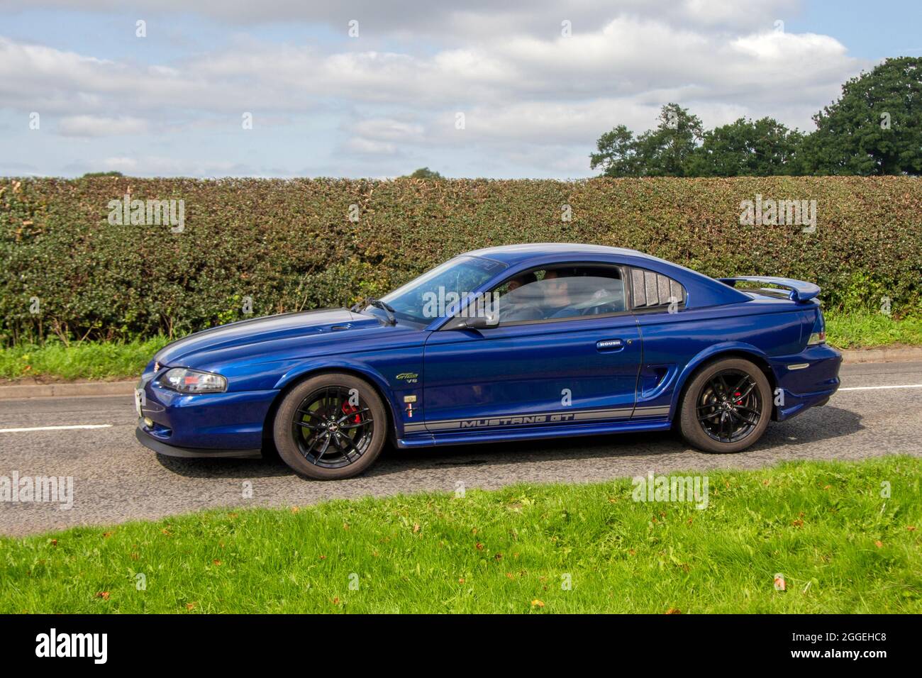 1996 90s blue Ford Mustang 4600cc, 4.6 litre, V8 Roush en-route to Capesthorne Hall classic August car show, Cheshire, UK Stock Photo