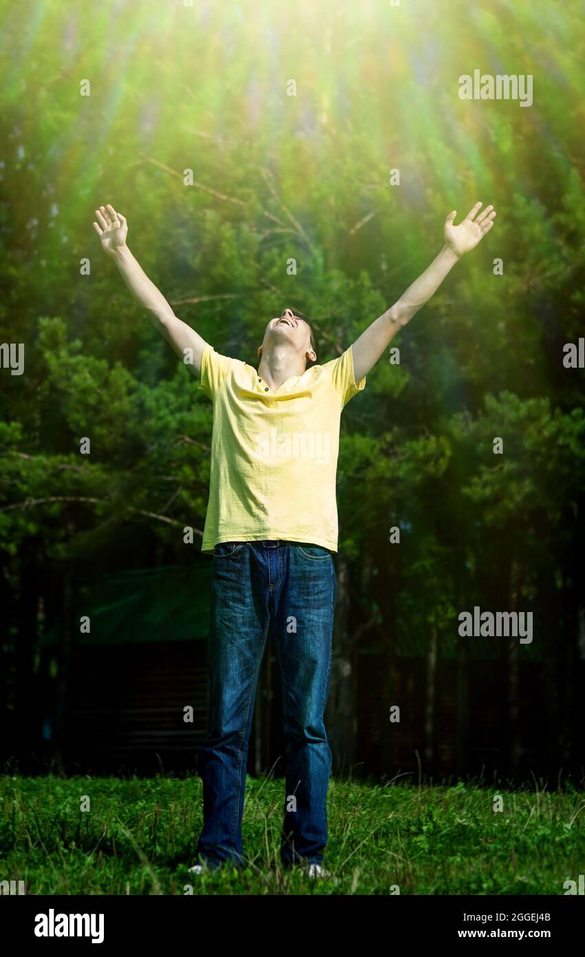 Toned Photo of Happy Young Man with Hands Up on the Nature Background ...