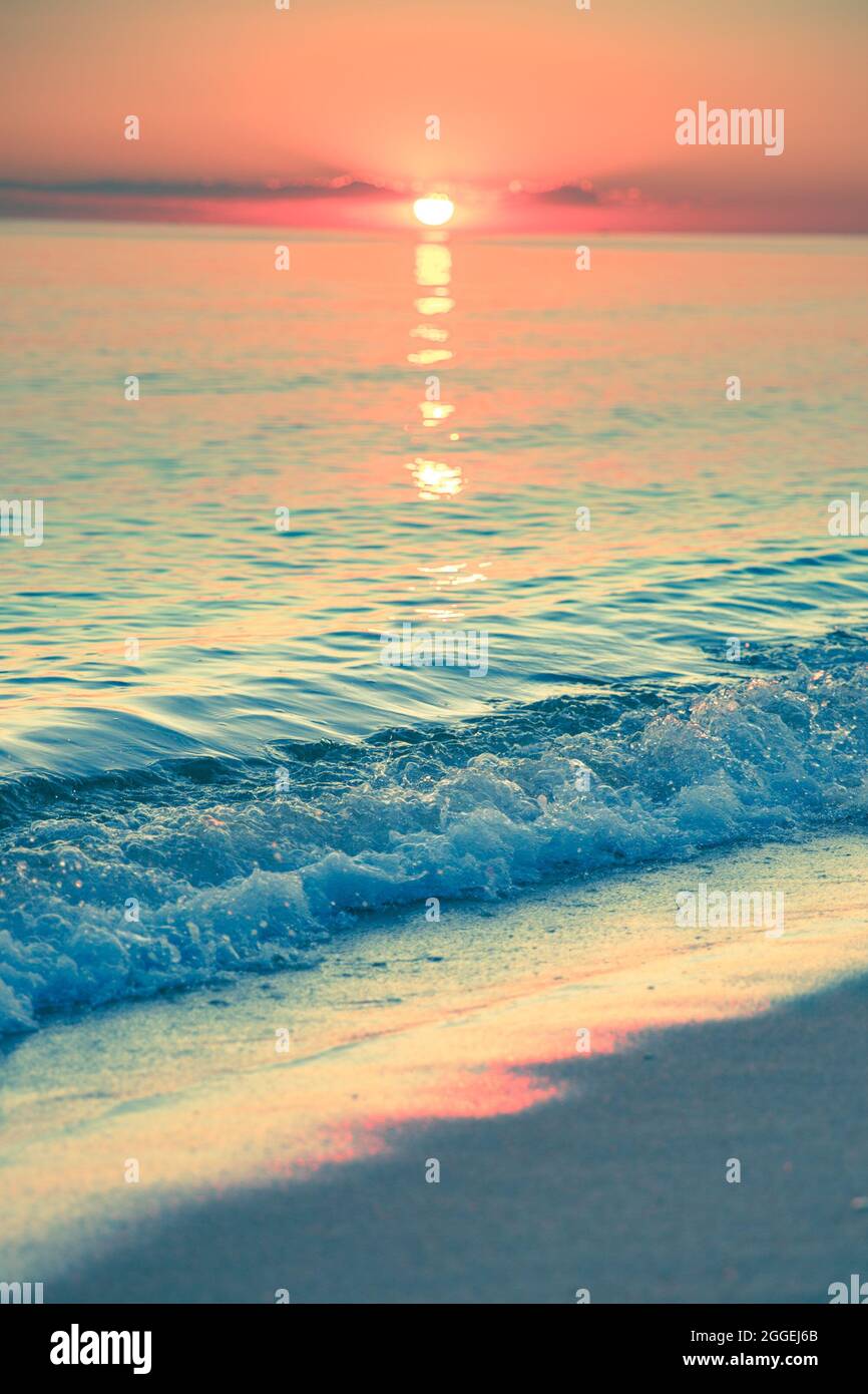 View from beach at sunset with ocean, colorful sky and sea Stock Photo