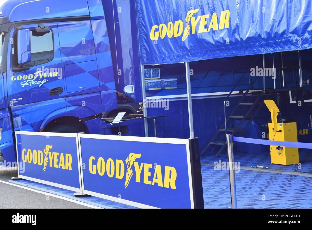 A Good Year awning, lorry and barriers at an event in the UK, publicizing their brand showing their trademarked winged foot of Mercury. Stock Photo