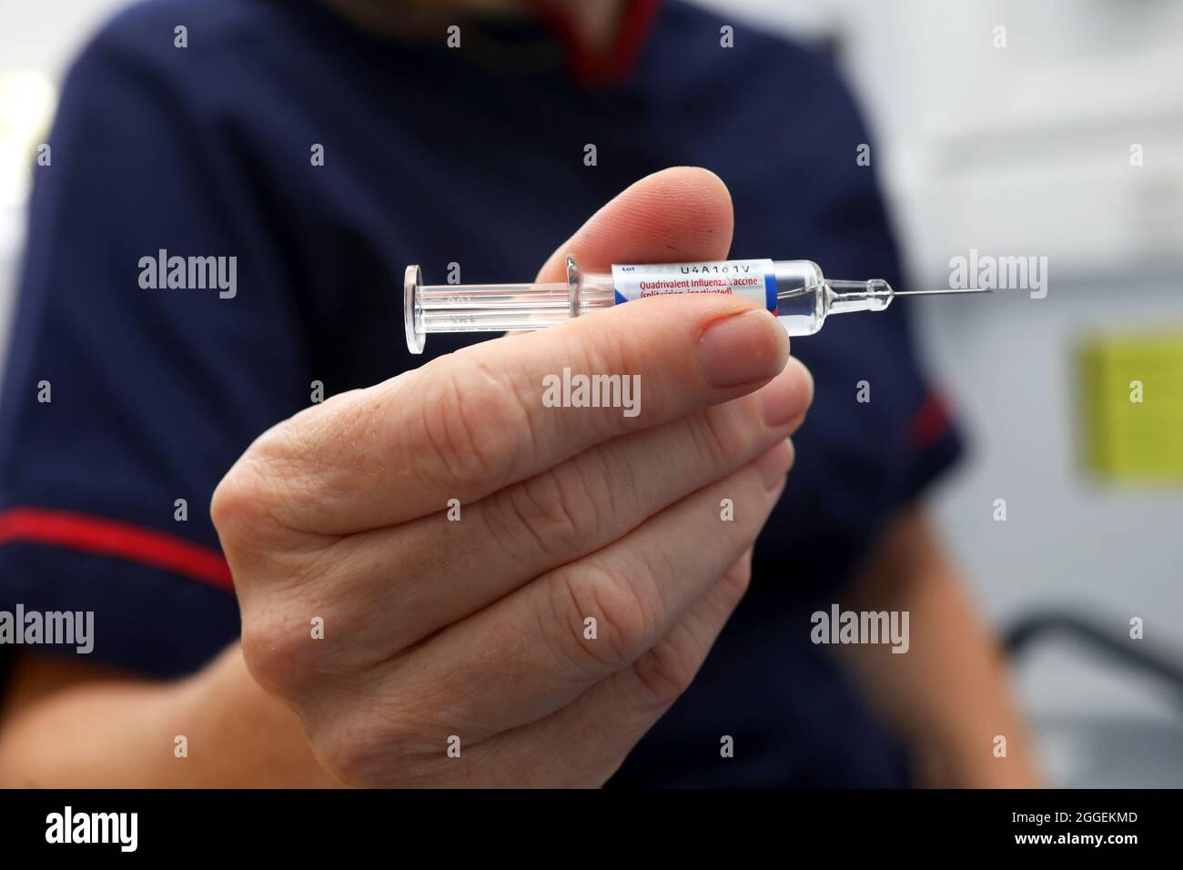 A nurse holding the flu jab at a surgery in Sussex, UK. Stock Photo