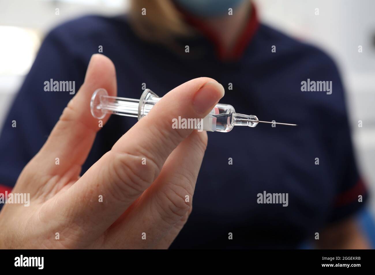A nurse holding the flu jab at a surgery in Sussex, UK. Stock Photo