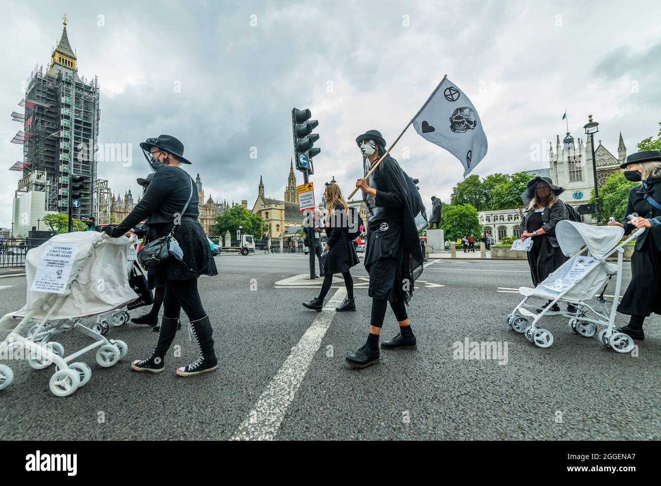 London, UK. 31st Aug, 2021. The white prams were pushed, passed parliament, b rebels in black mourning outfits as they call for an end to the pollution that affects the health of so many chidren around the world. Extinction Rebellion continues its two weeks with a prams protest in Parliament Square and Whitehall, under the overalll Impossible Rebellion name. Credit: Guy Bell/Alamy Live News Stock Photo