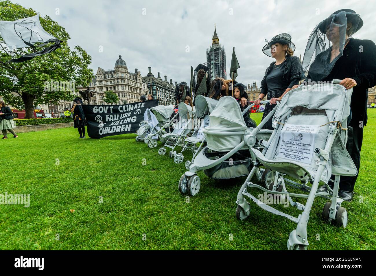London, UK. 31st Aug, 2021. The white prams were pushed b rebels in black mourning outfits as they call for an end to the pollution that affects the health of so many chidren around the world. Extinction Rebellion continues its two weeks with a prams protest in Parliament Square and Whitehall, under the overalll Impossible Rebellion name. Credit: Guy Bell/Alamy Live News Stock Photo