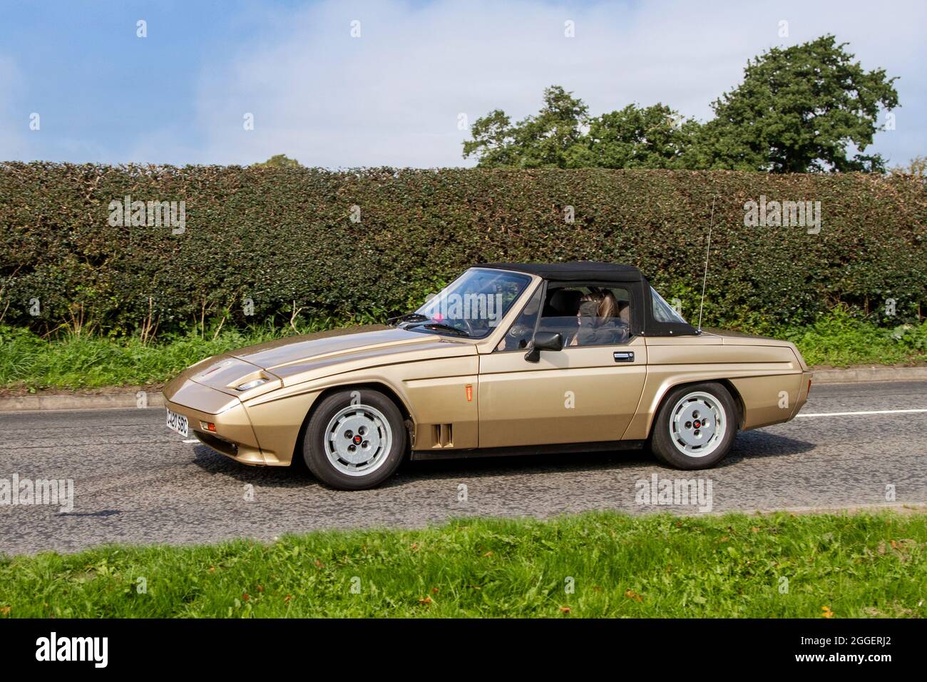 1986 80s eighties Gold Reliant Scimitar 1596cc 2dr cabrio, en-route to Capesthorne Hall classic August car show, Cheshire, UK Stock Photo