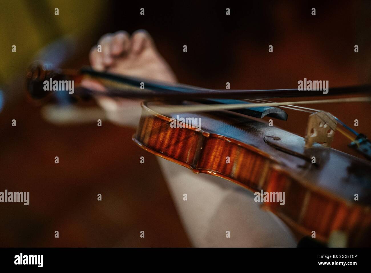 Closeup of a female violinist playing violin at the concert, focus on ...