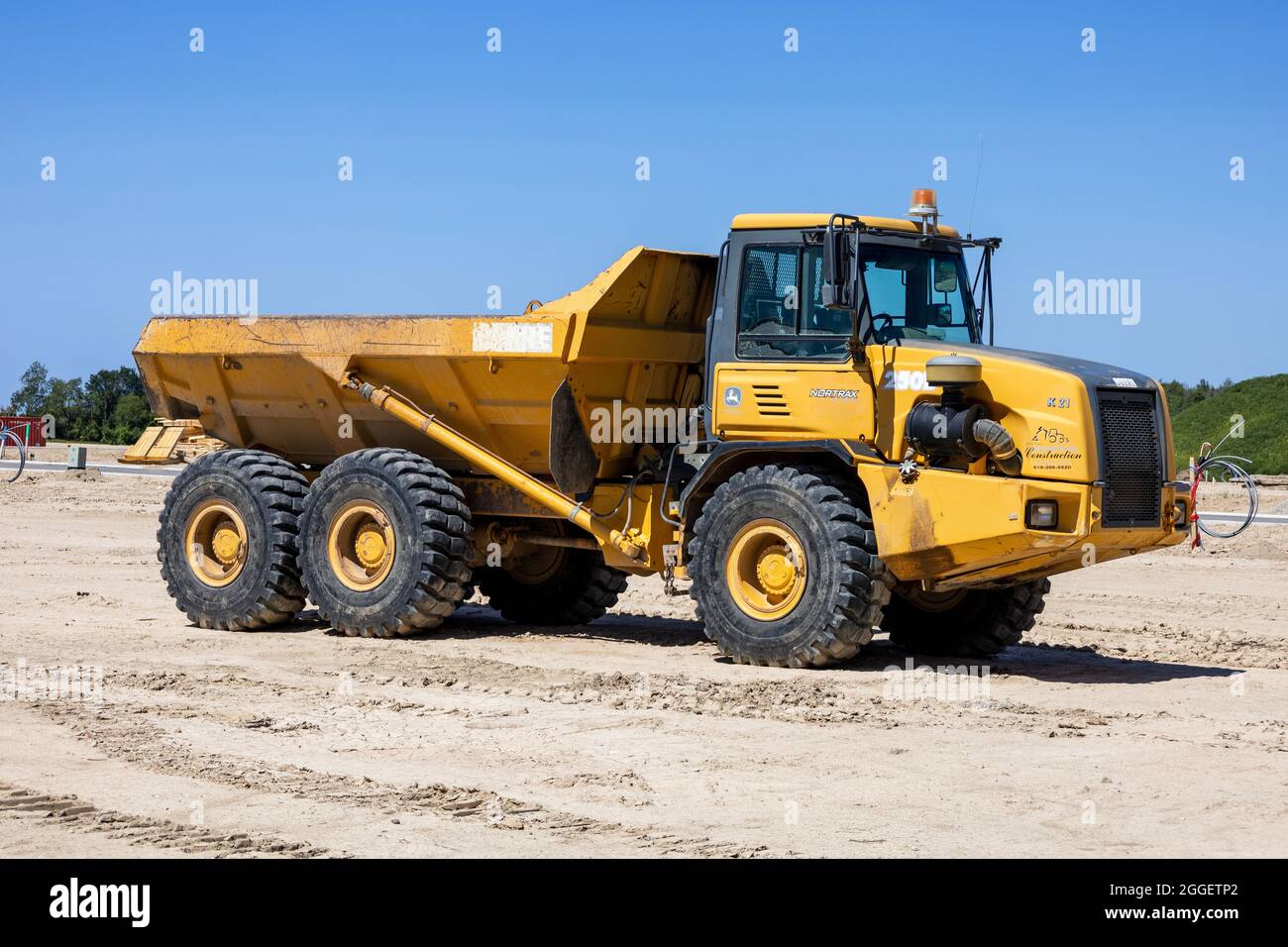 Yellow John Deere 250D Articulated Dump Truck Construction Heavy Vehicle Stock Photo