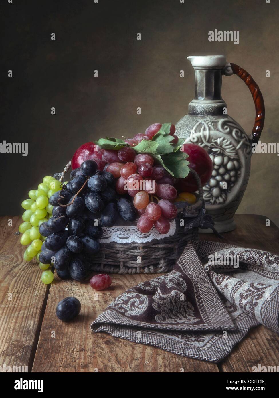 Still life with grapes and wine jug Stock Photo