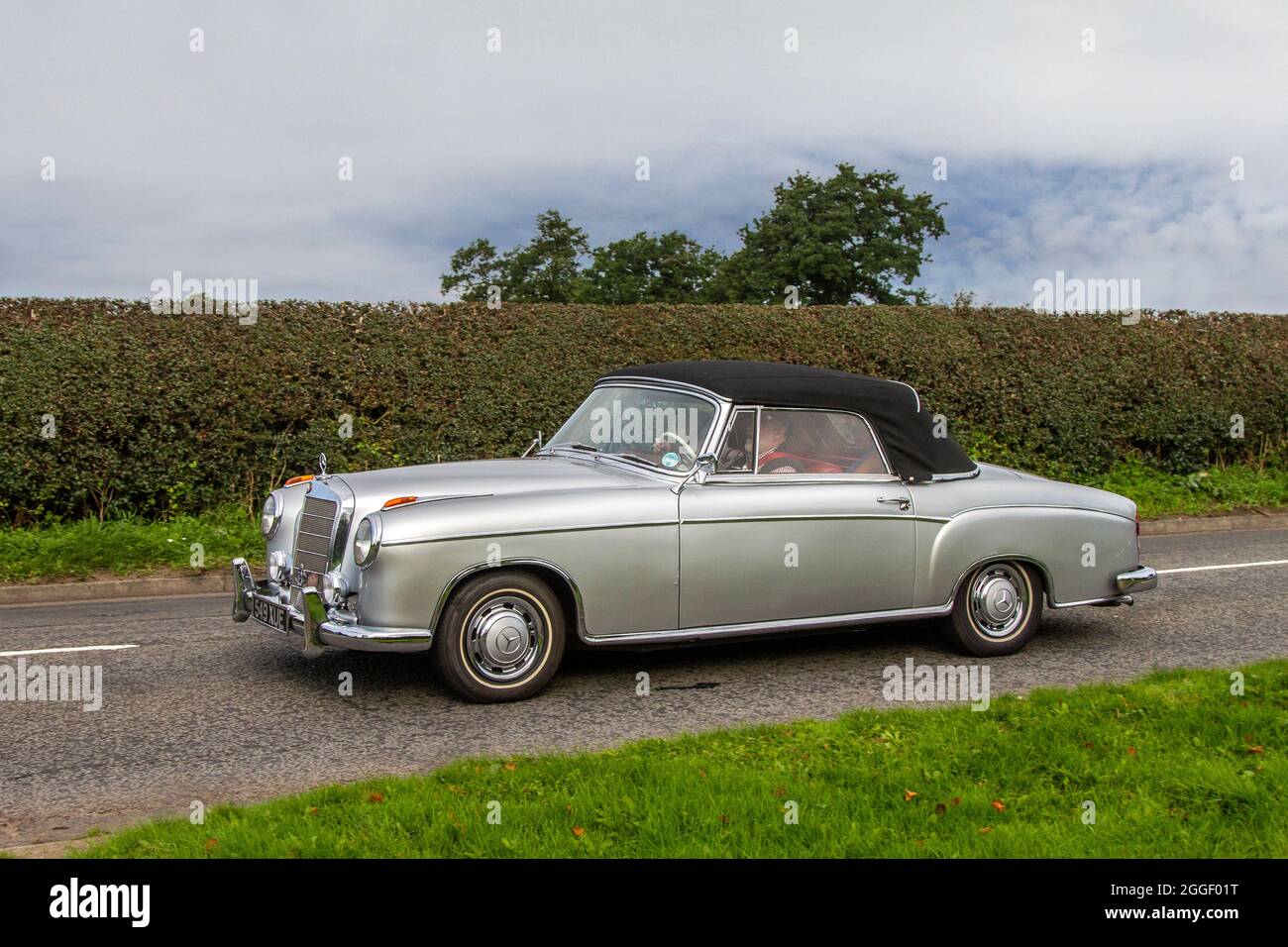 1960 60s sixties grey silver Mercedes Benz S 2dr cabrio en-route to Capesthorne Hall, Vintage lassic August car show, Cheshire, UK Stock Photo