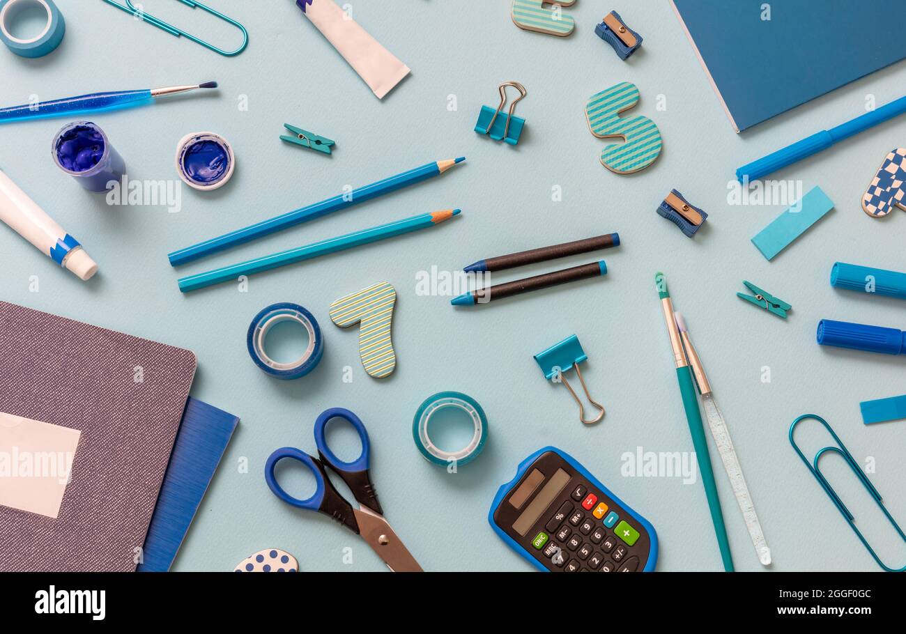 School supplies on wooden desk. Kid creativity flat lay Stock Photo by rawf8