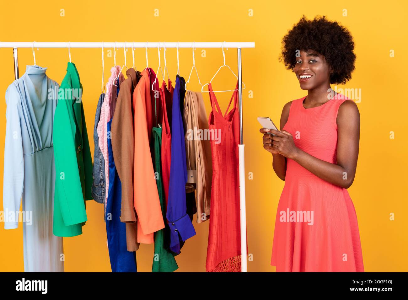 Mobile Shopping. Contented Black Woman Buying Clothes Online Via
