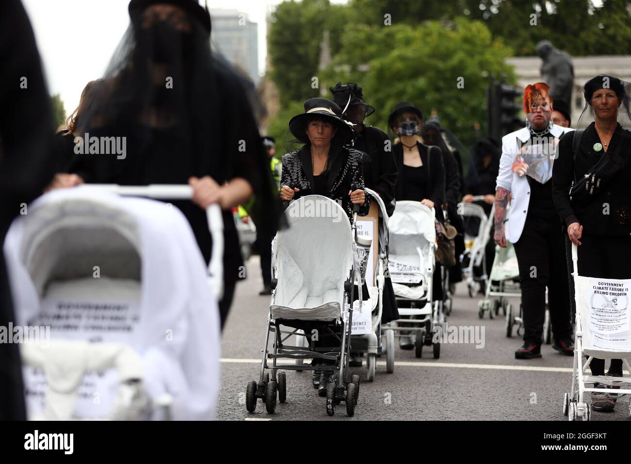 London, England, UK. 31st Aug, 2021. Climate change campaign group Extinction Rebellion activists wearing funeral dresses glue themselves to prams outside the main entrance of Downing Street during a demonstration in Westminster. (Credit Image: © Tayfun Salci/ZUMA Press Wire) Stock Photo
