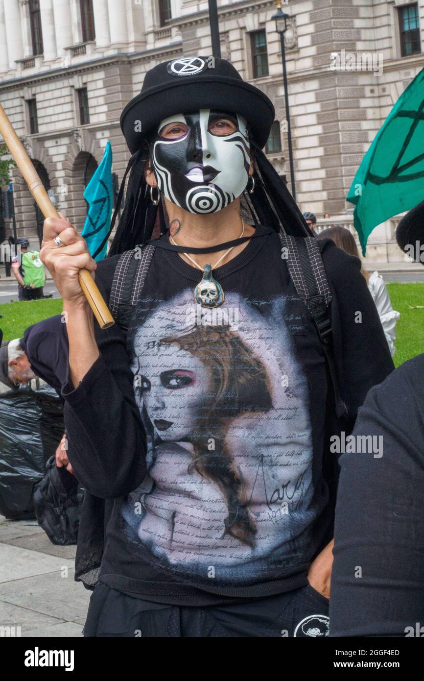London, UK. 31st August 2021. Extinction Rebellion campaigners in black mourning prepare to walk at funeral pace from Parliament Square to Trafalgar Square pushing white painted prams & Buggies demanding the government stop fossil fuel funding which has led to climate failure which is killing children. Peter Marshall/Alamy Live News Stock Photo