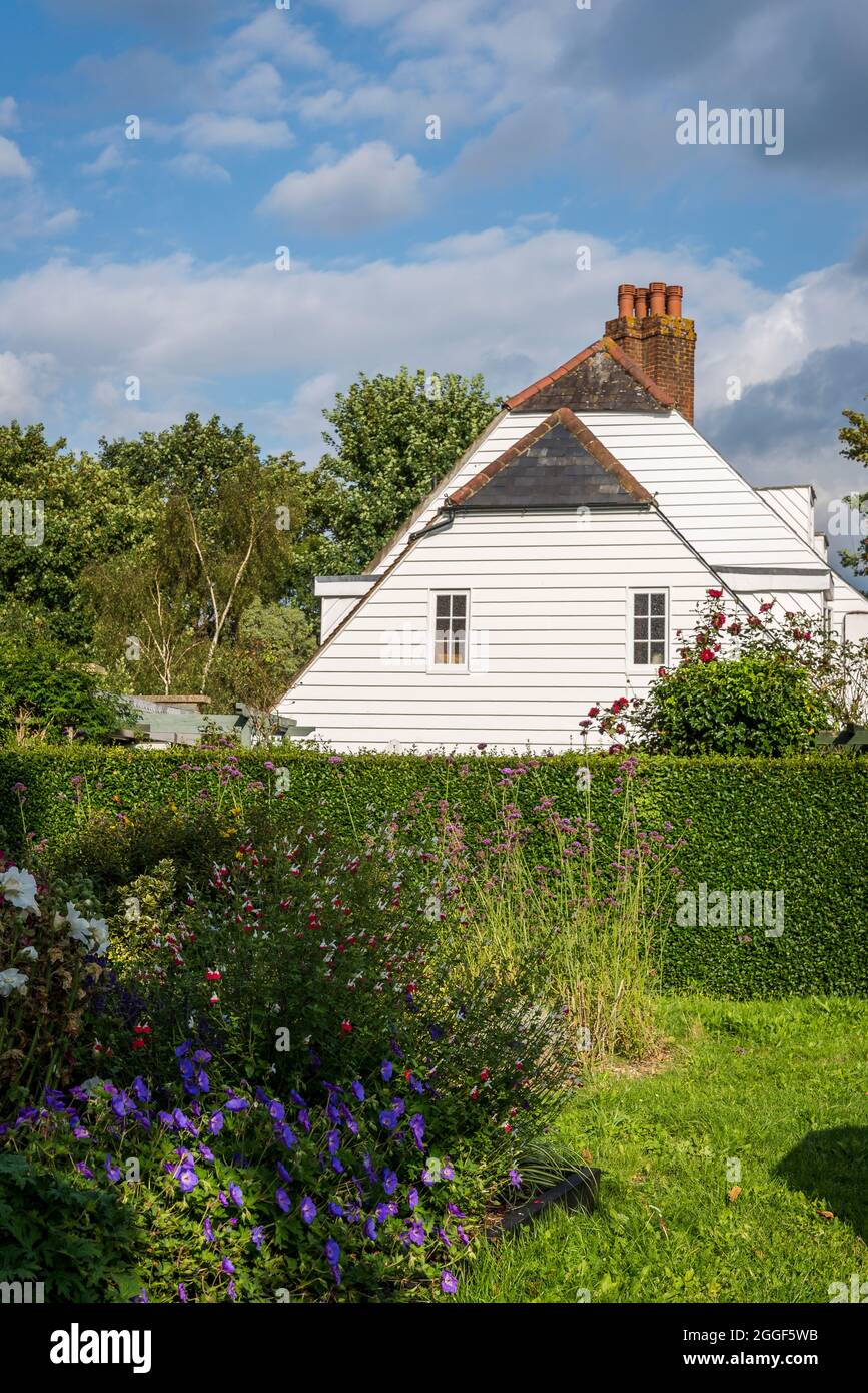 Garden, hedge and white clapboard house, Epsom, Surrey,, England, UK Stock Photo