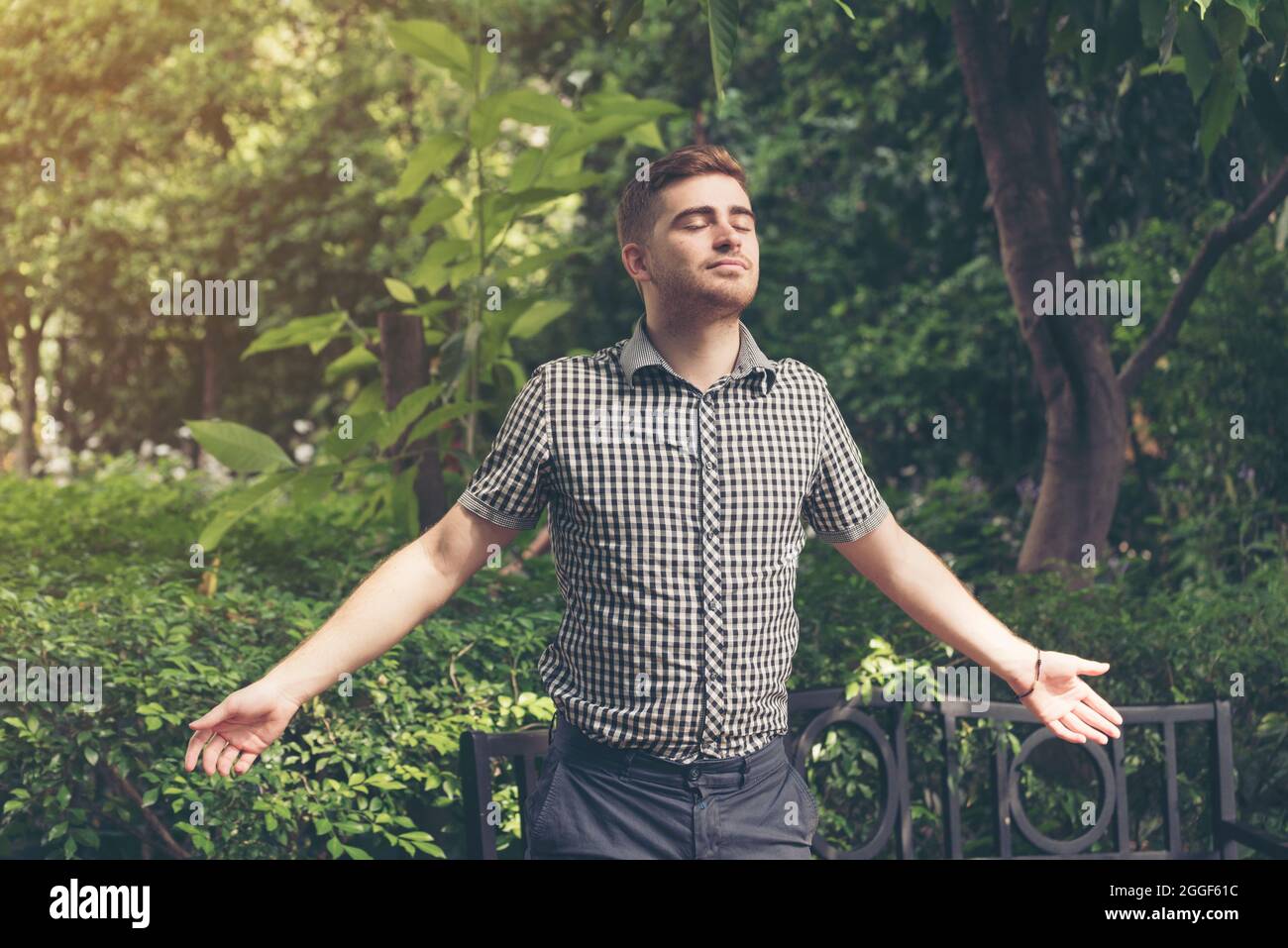 Man feeling relax while enjoy freedom in the park. Relaxation lifestyle concept. Stock Photo