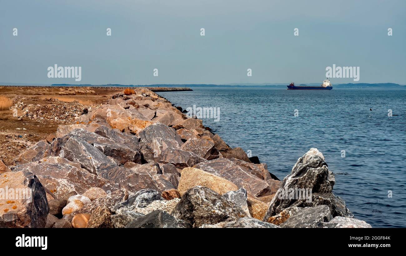 Cargo ship on the way to the port in Aarhus, Denmark Stock Photo