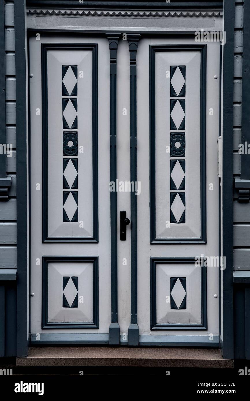 Closeup on a gray double door with wood carving Stock Photo