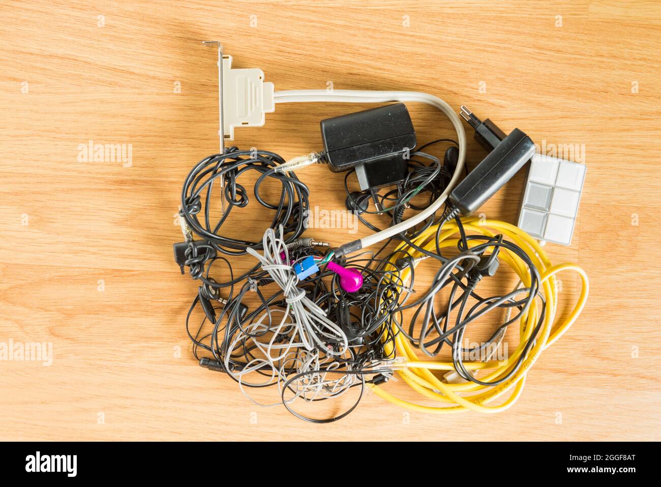 Obsolete electronic and technological objects arranged on a parquet floor. Technological waste and its recycling is one of the problems to be tackled Stock Photo