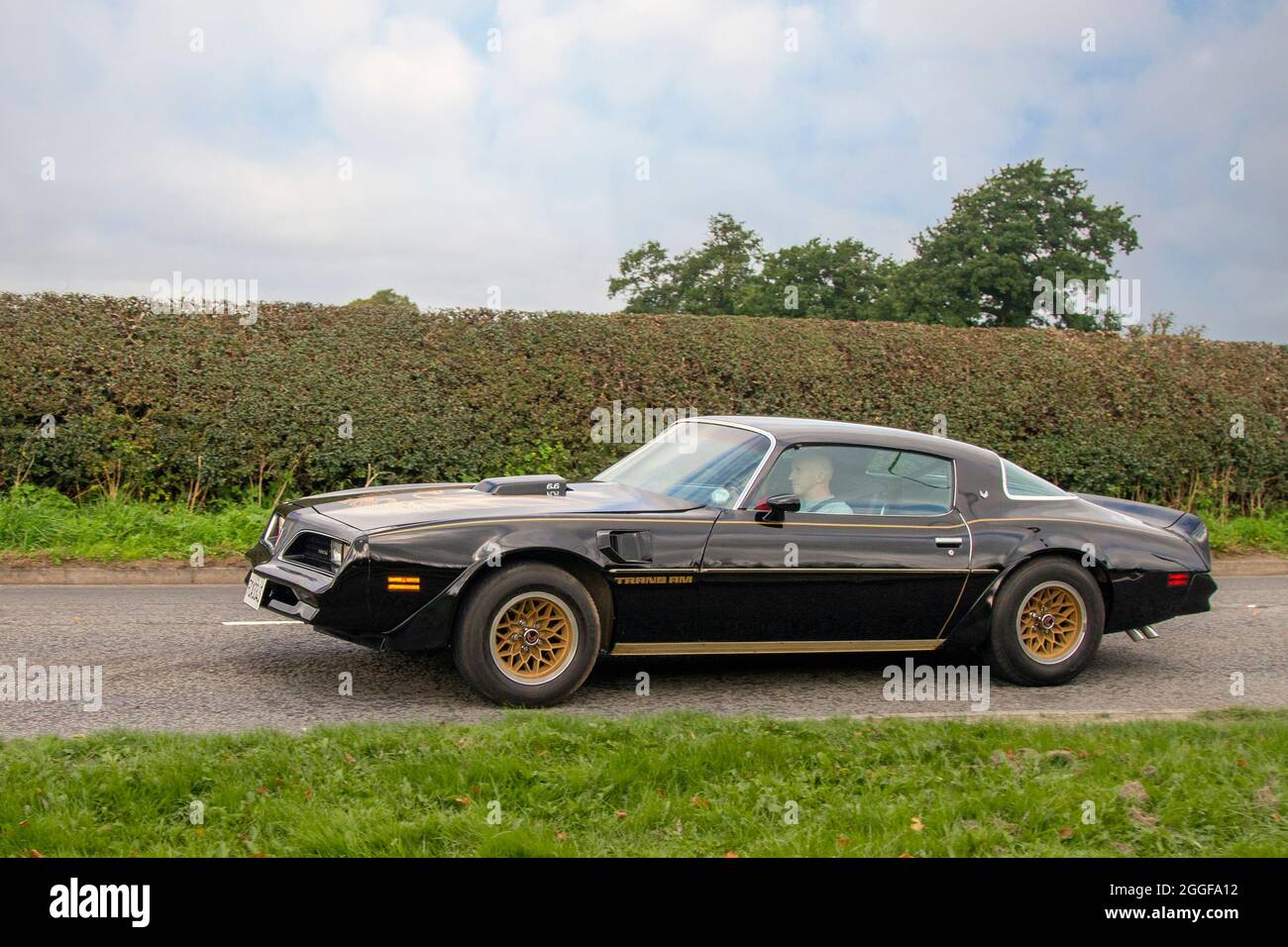 1978 70s seventies American Pontiac Black-And-Gold Trans Am en-route to Capesthorne Hall classic August car show, Cheshire, UK Stock Photo