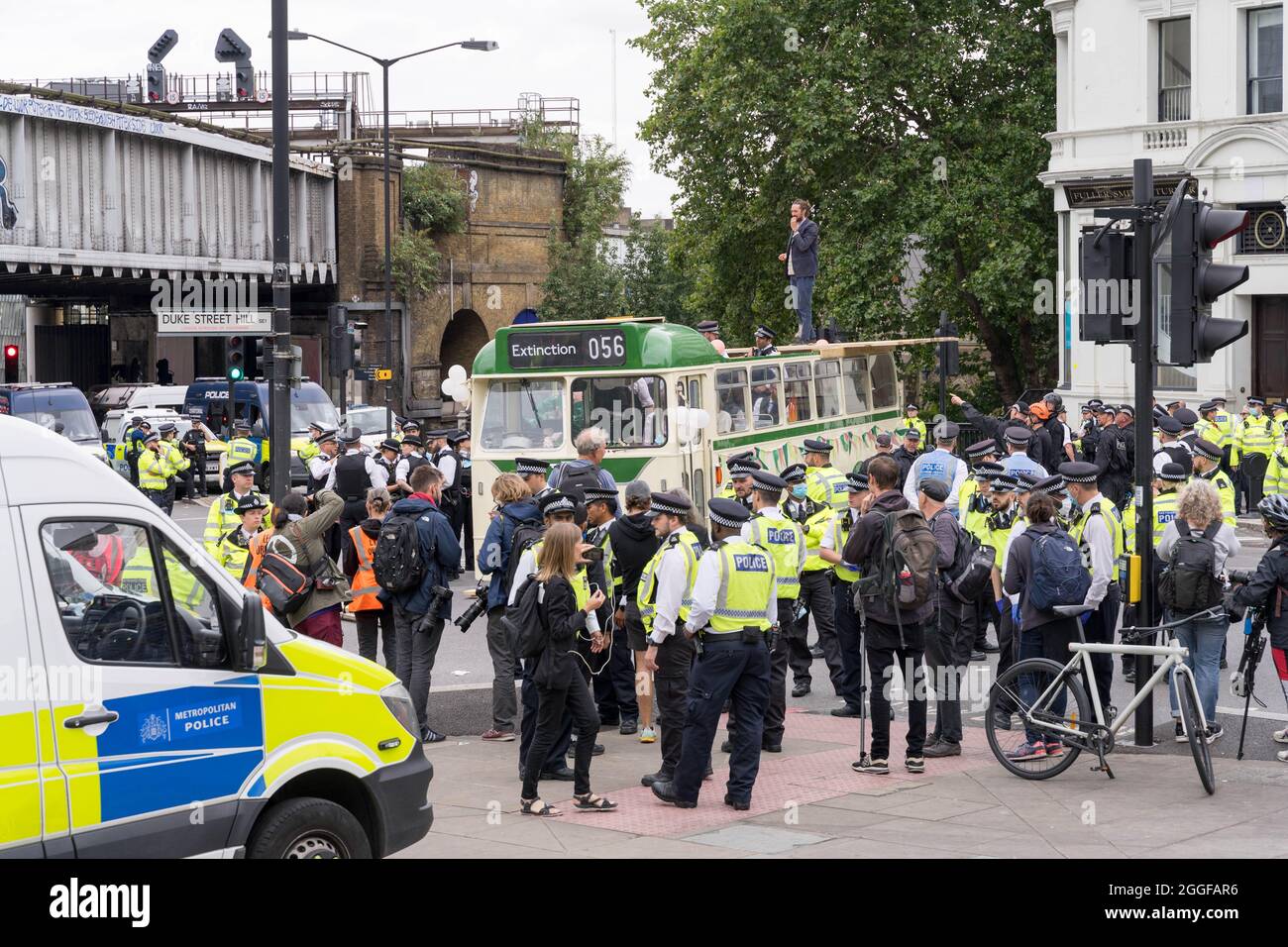 London, UK. 31sth August 2021. Extinction Rebellion XR blocks off London Bridge to traffics from Borough market to monument as climate protests continue. demonstration  vintage wedding  bus is draped in the banner saying 'invest in life'.Credit: Xiu Bao/Alamy Live News Stock Photo