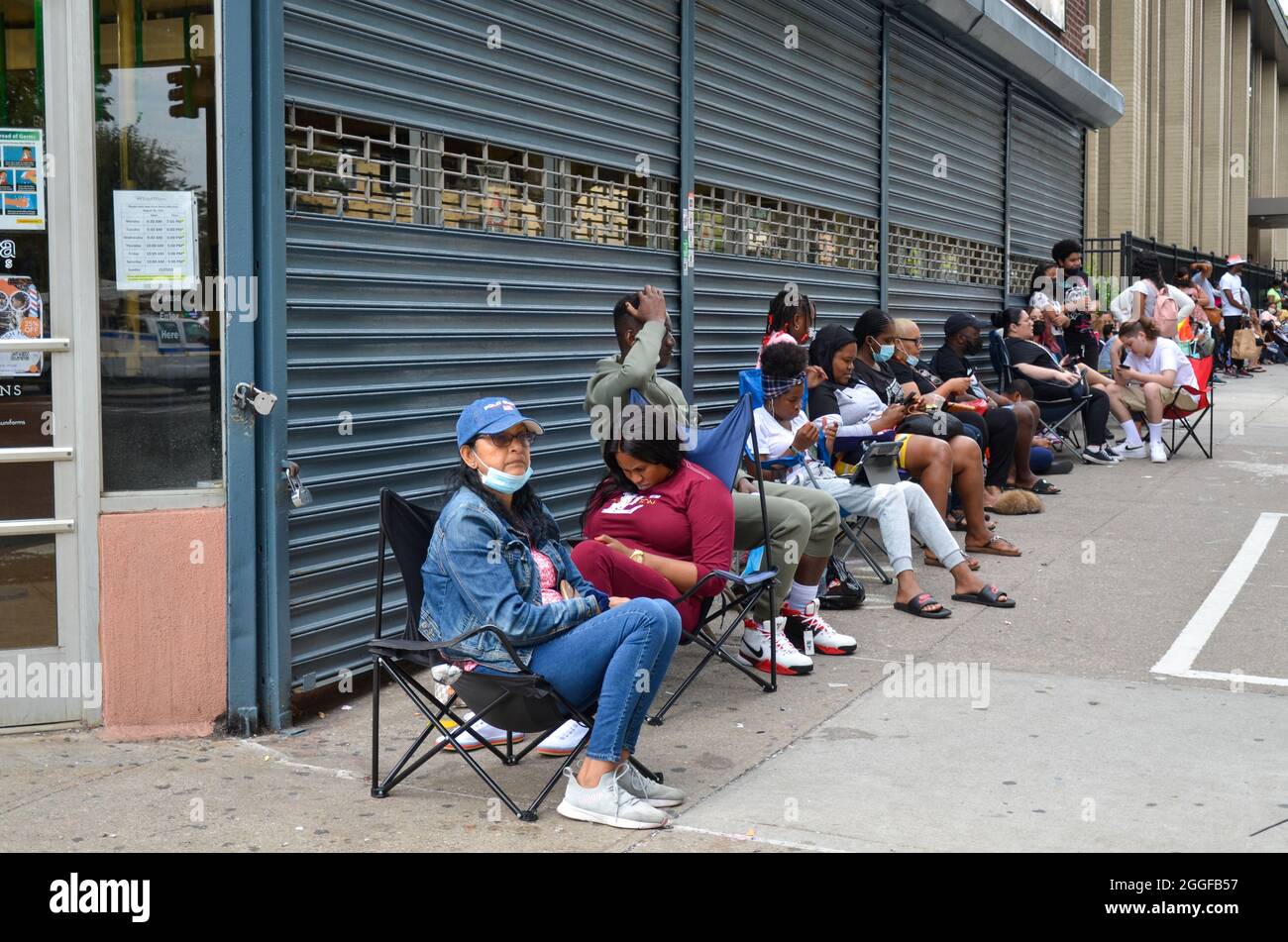 Parents of school students camping outside a local school dress retailer in the Bronx. Stock Photo