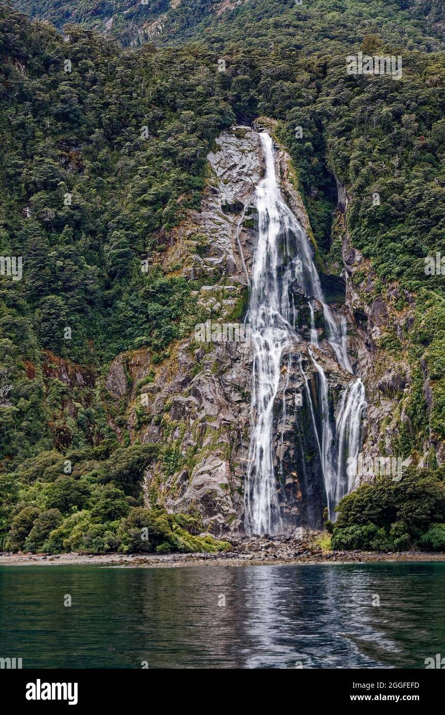 Stirling Falls; waterfall, mountainside, green vegetation, nature, cascading water, movement, high, Milford Sound, Fiordland National Park, Te Anau, N Stock Photo