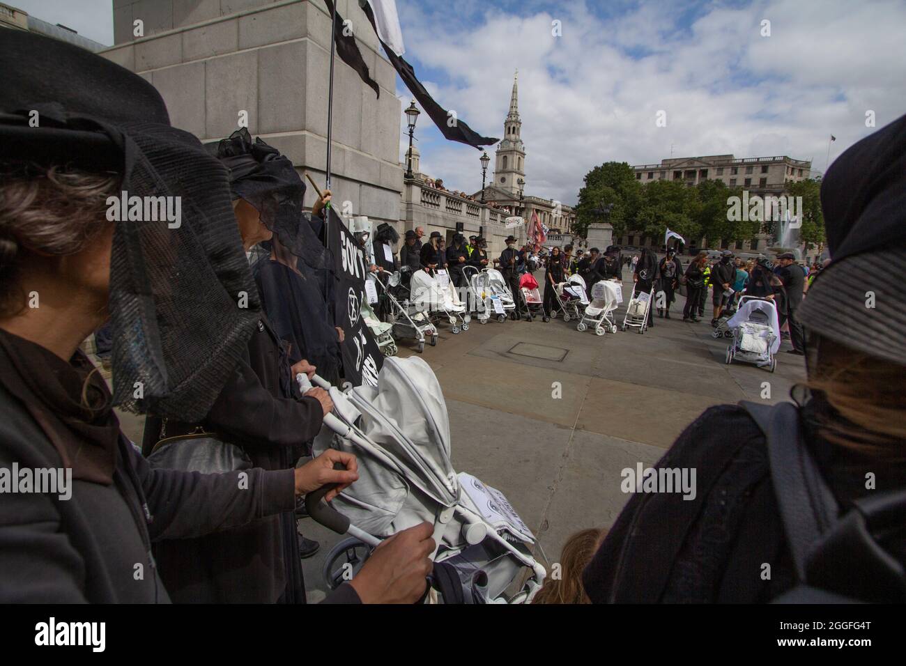 Extinction Rebellion activists London 31 August 2021. Pram action protesters in Central London, walk with ghostly white prams dressed in funeral attire Stock Photo
