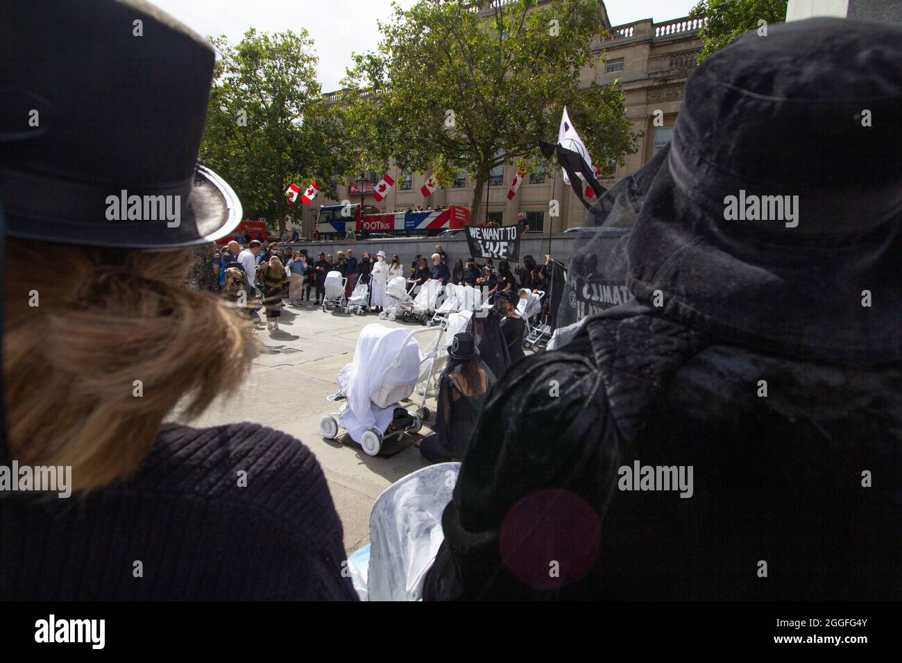 Extinction Rebellion activists London 31 August 2021. Pram action protesters in Central London, walk with ghostly white prams dressed in funeral attire Stock Photo