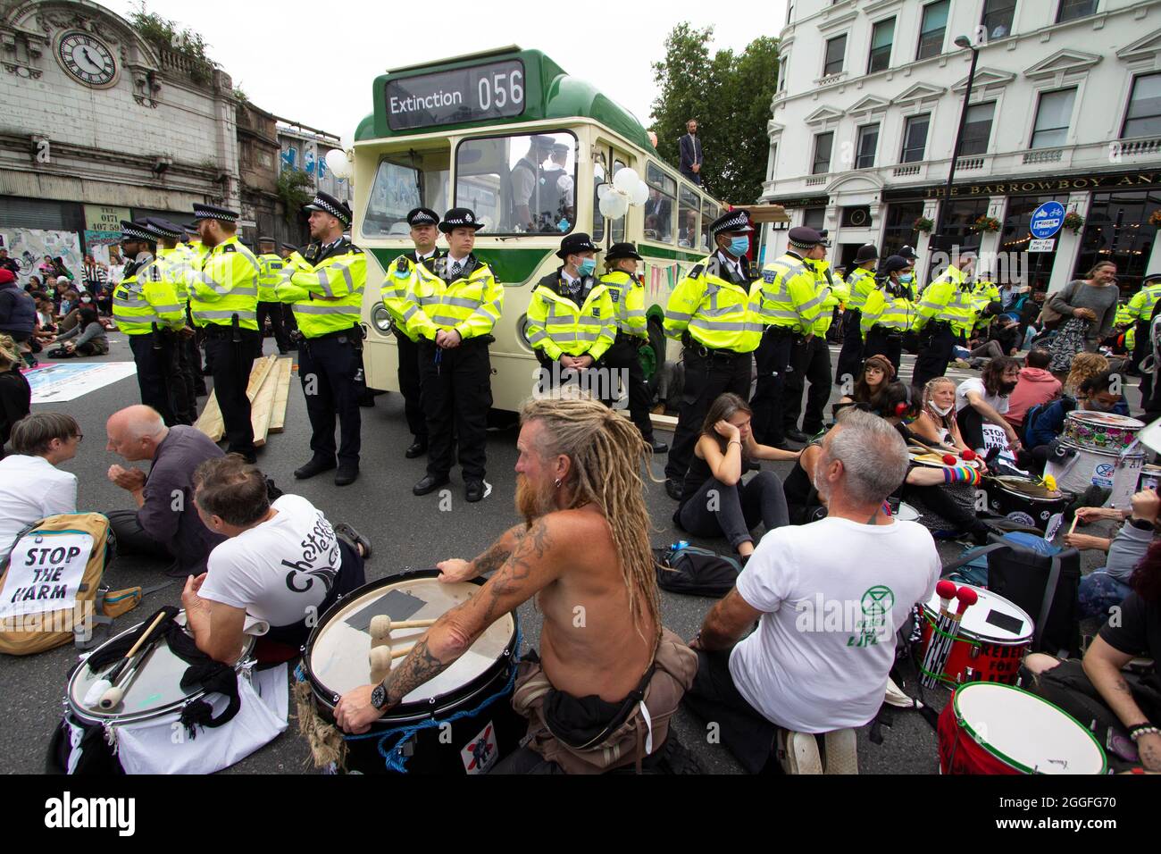 Extinction Rebellion activists London 31 August 2021. Protesters block London Bridge with a bus as part of ongoing XR, protests in London, while police officers guard bus Stock Photo