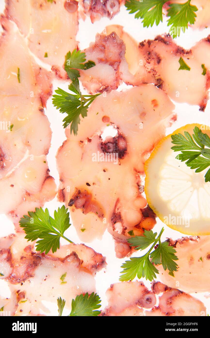 Presentation portion of octopus carpaccio co lemon and olive oil Stock Photo