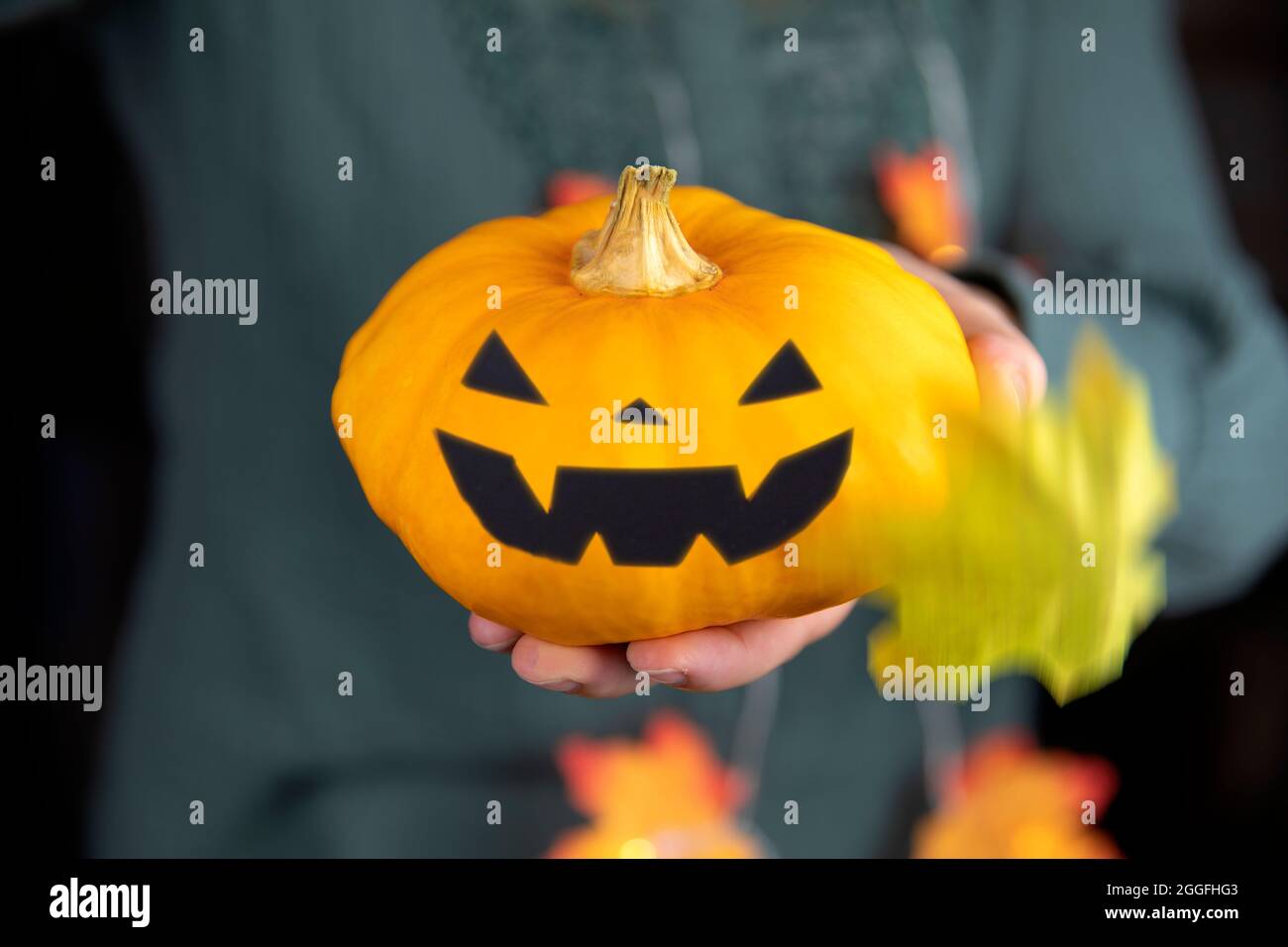 orange pumpkin head for Halloween in hand. scary head Jack o lantern ...
