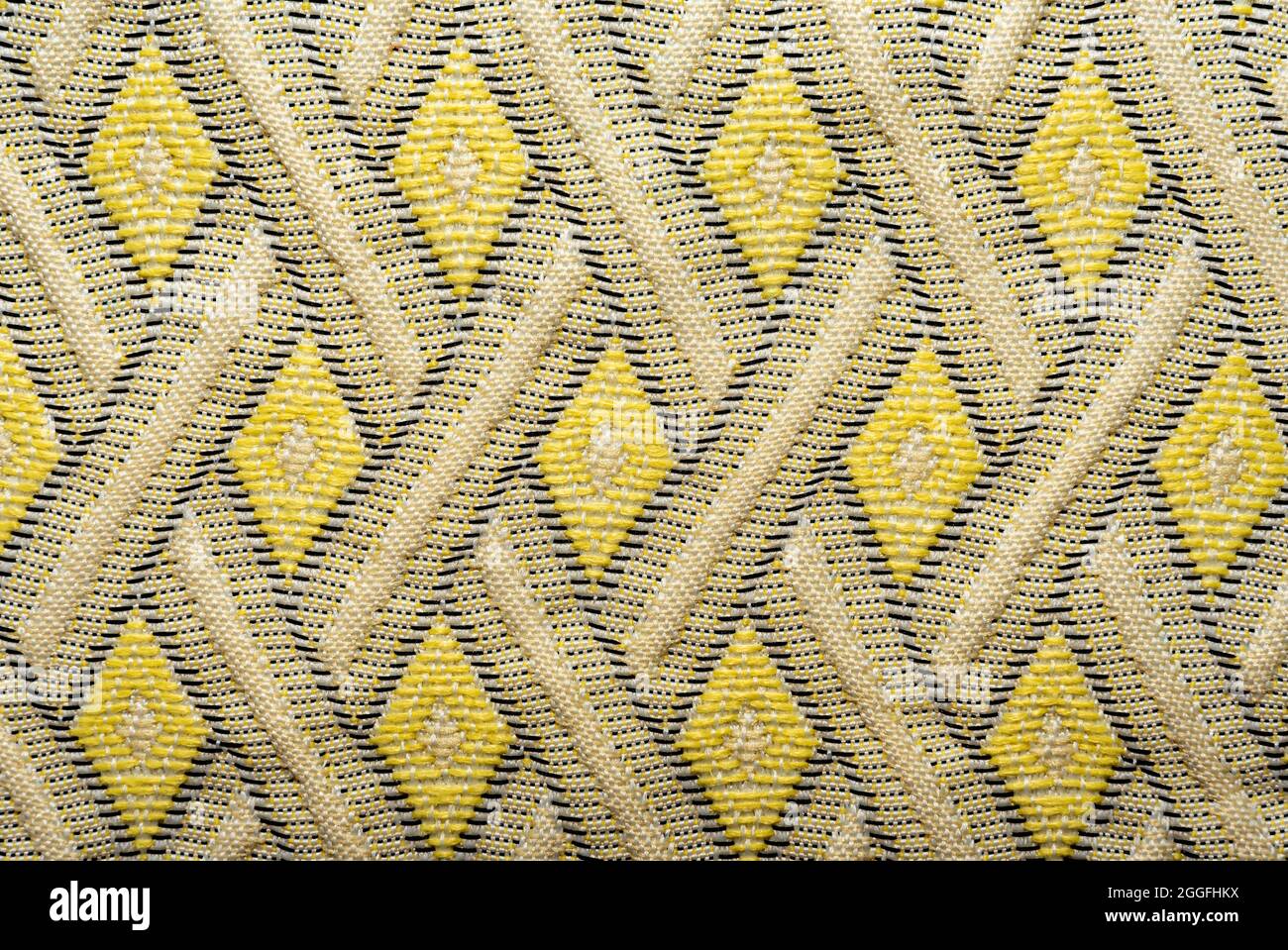 Fabric background. The texture of the material is in the form of geometric rhombuses and squares of shapes. Pattern Stock Photo