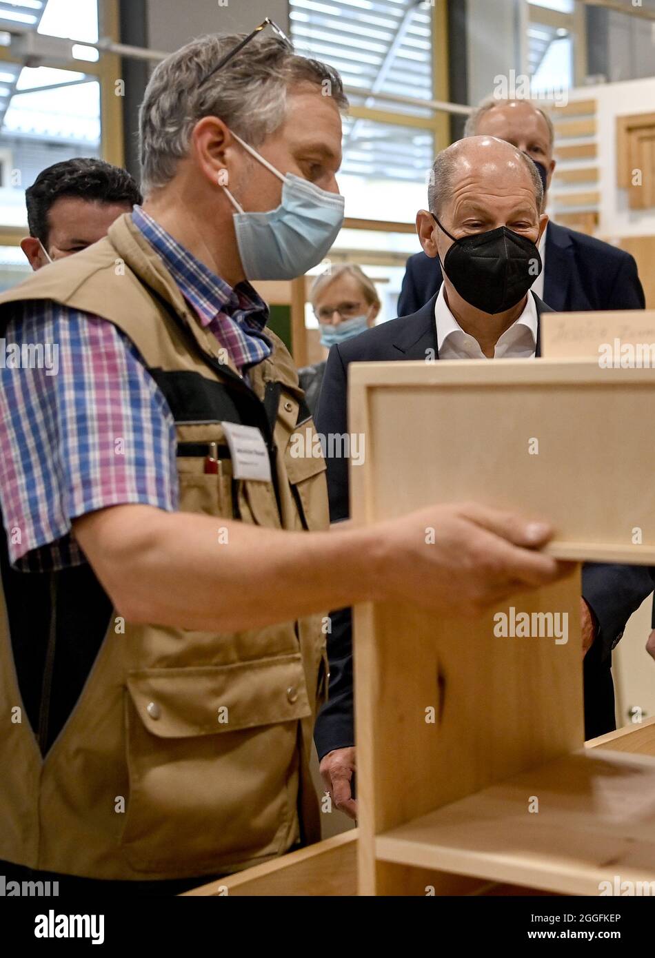 Potsdam, Germany. 31st Aug, 2021. Hubertus Heil (SPD, m), Federal Minister of Labour and Social Affairs, and Olaf Scholz (SPD, r), Federal Chancellor candidate, let Jens-Achim Weinert, workshop manager, show them the workshops of the Oberlin Berufliche Schulen training centre. Credit: Britta Pedersen/dpa-Zentralbild/dpa/Alamy Live News Stock Photo