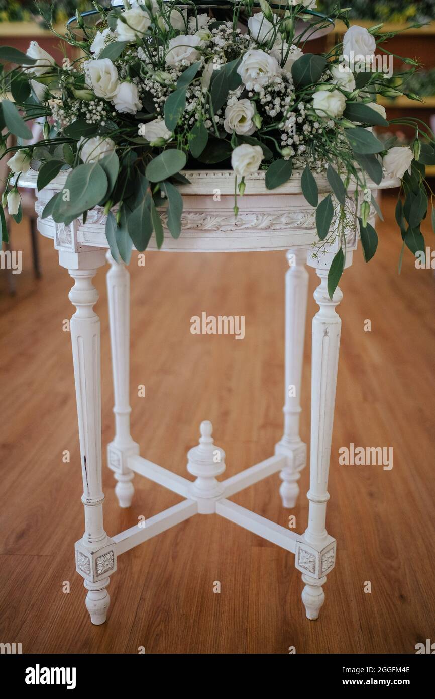 Beautiful flower arrangement on a white baluster console Stock Photo