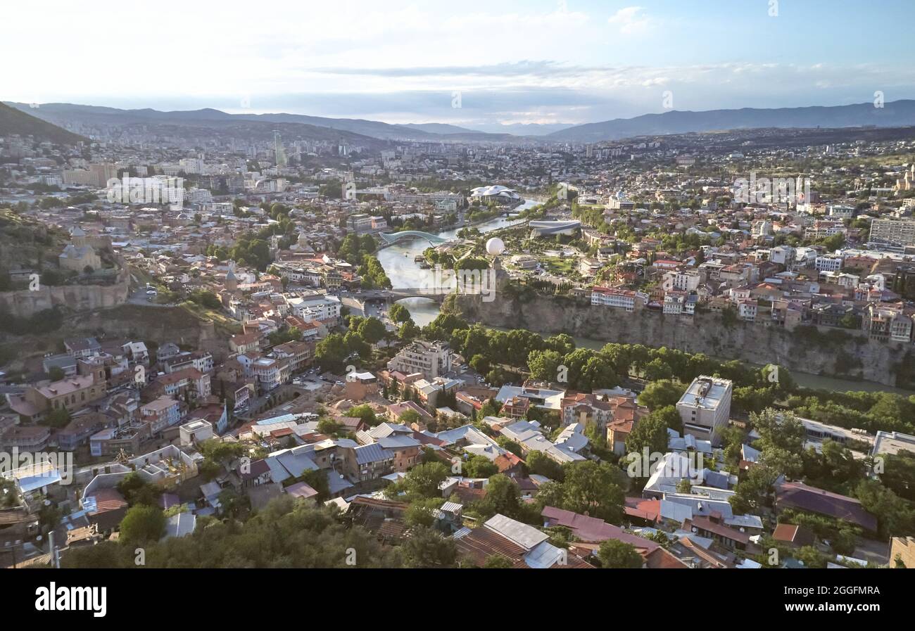 Cityscape of Tbilisi town in bright sunny day aerial drone view Stock Photo