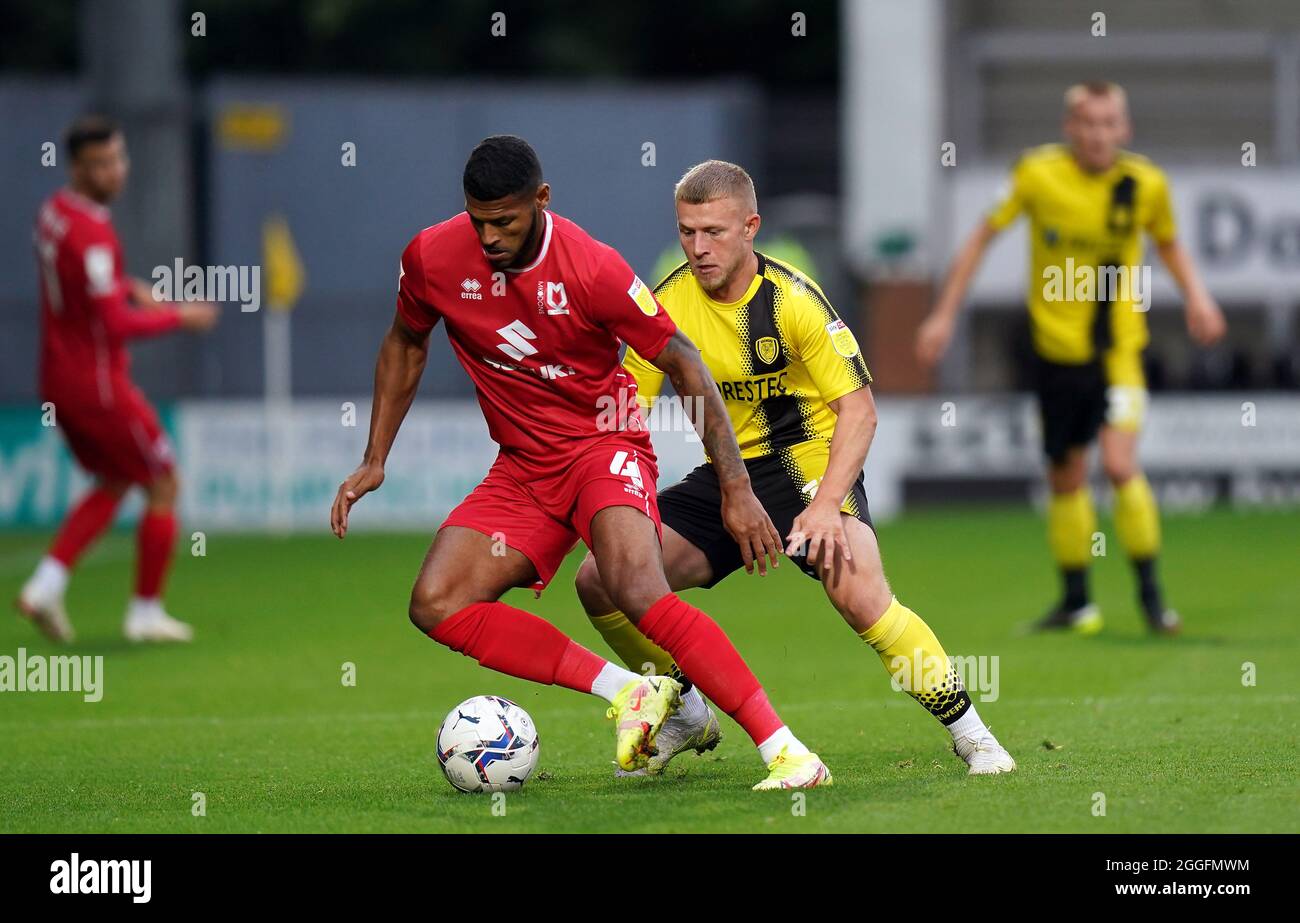 Burton Albion's Danny Rowe and Milton Keynes Dons Zak Jules (left) battle for the ball during the Papa John's Trophy, Southern Section Group C match at the Pirelli Stadium, Burton upon Trent. Picture date: Tuesday August 31, 2021. Stock Photo