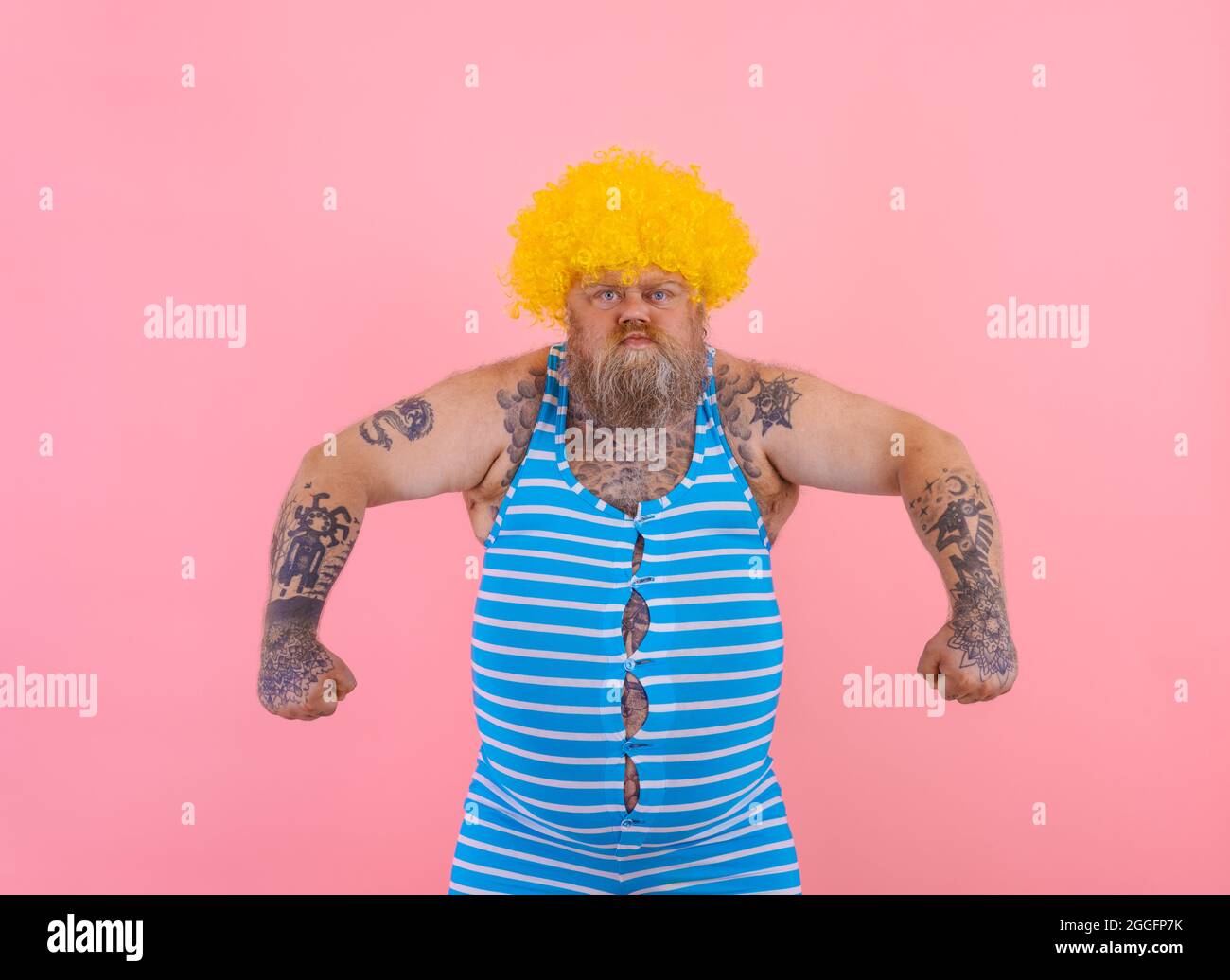 Angry man with yellow wig and swimsuit is ready to the summer Stock Photo