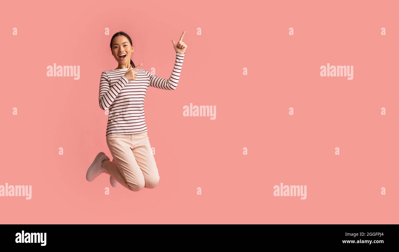 Crazy Sales. Cheerful Excited Asian Female Jumping In Air And Pointing ...