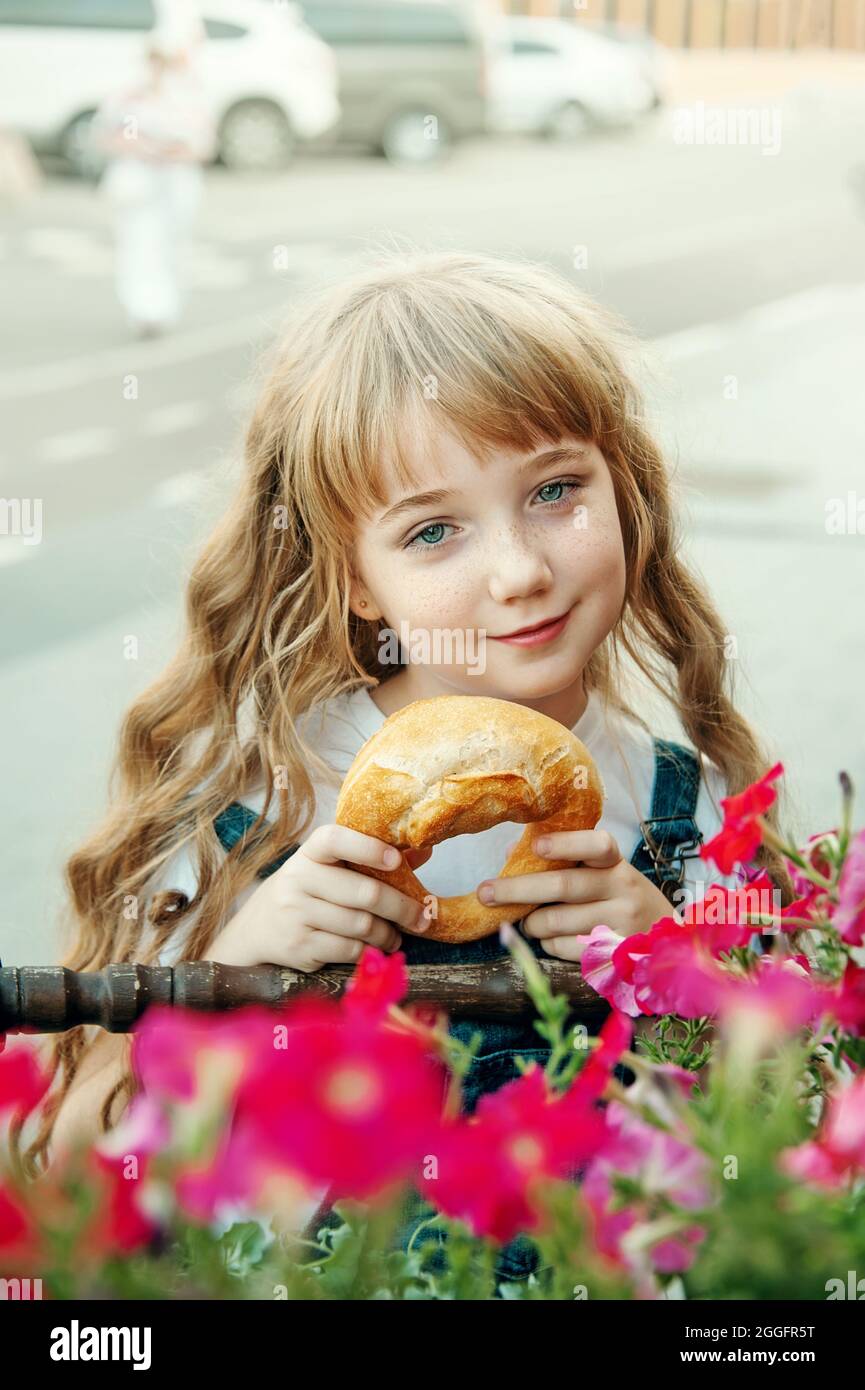 Lovely Blue Eyed Girl With A Pretzel On The Street Portrait Of A Blue Eyed Girl With Long